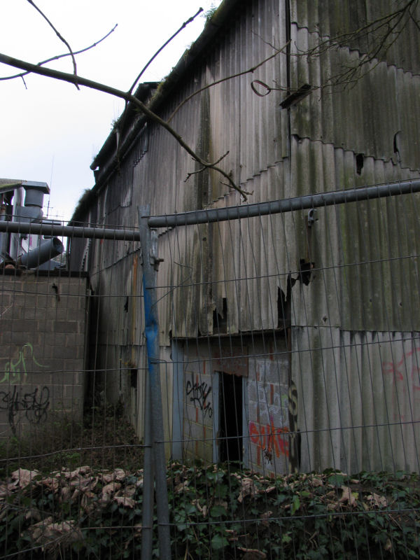 asbestos clad building Freshford Mill graffiti on cladding